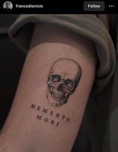 a skull with the words mementoo mori written on it's arm