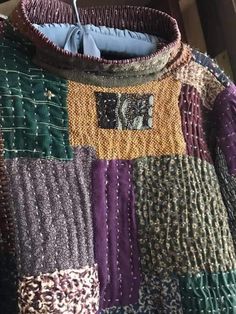 an old jacket with many different colors on it