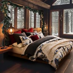 a large bed sitting inside of a bedroom on top of a wooden floor next to a window