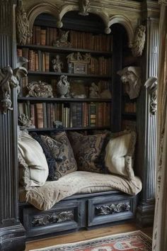 an old bookcase with many books and pillows on it in a room filled with furniture