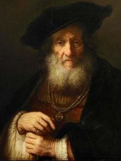 an old man with a long beard wearing a black hat and holding his hand on his chest