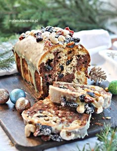 a loaf of cake sitting on top of a wooden cutting board next to christmas decorations