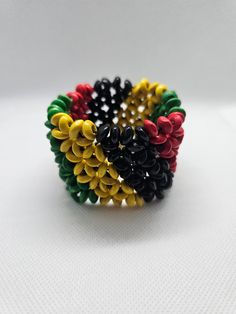 Show your love for Jamaica and Bob Marley with this colourful wooden bangle bracelet.  The tie closure allows for an adjustable fit from sizes 7 to 8.5 inches. Perfect to add a  Jamaican flare to any outfit. Order now, happy shopping. Wooden Bangle Bracelet, Wooden Bangle, String Bracelet, Bob Marley, Bangle Bracelet, Jamaica, Bangle Bracelets, Happy Shopping, Jewelry Bracelets