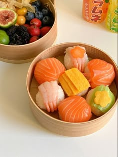 two bowls filled with different types of sushi next to each other on a table