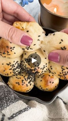 a person with pink nails is holding some bread