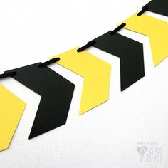 black and yellow paper arrows are hanging on the wall