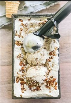 an ice cream sundae with pecans, nuts and a scoop of ice cream