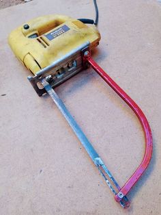 a yellow and red hose connected to an electrical device on the ground with wires attached