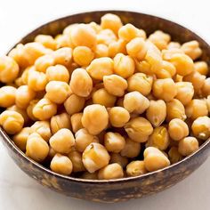 a bowl filled with chickpeas sitting on top of a table