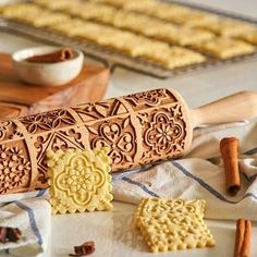 some cookies and cinnamon sticks on a table