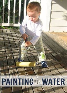 a toddler standing on a porch playing with a toy