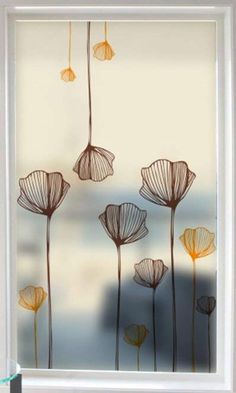 a window with flowers drawn on it in front of a white frame and blue background