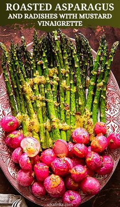 roasted asparagus and radishes with mustard vinaiette on a plate