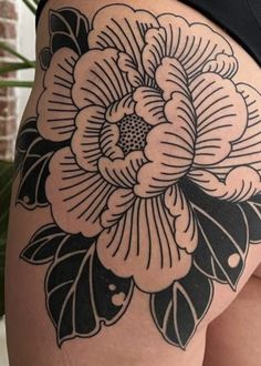 a woman's thigh with black and white flowers on it