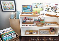 a book shelf filled with lots of books and other children's toys on top of a hard wood floor