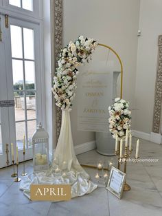 a wedding arch with flowers and candles