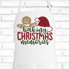 a white apron with the words baking christmas memories on it and a ginger in a santa hat