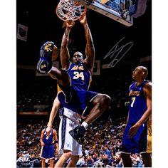 an autographed photograph of a basketball player dunking the ball in a game