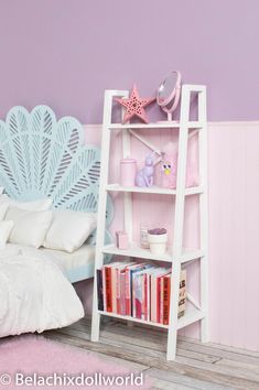 a white book shelf with books on it next to a bed and pink walls in a girls'bedroom