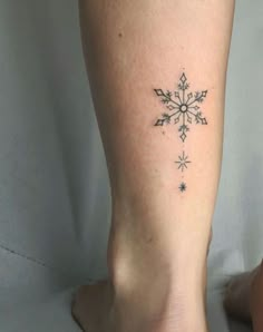 a snowflake tattoo on the leg of a woman's foot is shown