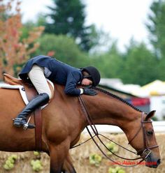 a woman riding on the back of a brown horse