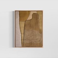 an abstract painting hangs on the wall next to a white wall with a wooden frame