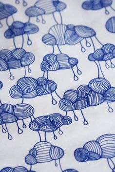 blue and white fabric with clouds on it