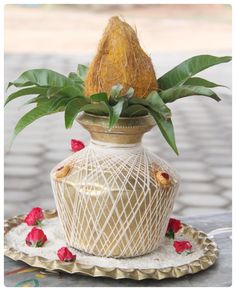 a vase with flowers in it sitting on a tray