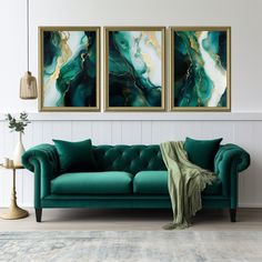 a living room with two paintings on the wall and a couch in front of it