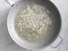 a frying pan filled with food on top of a white counter