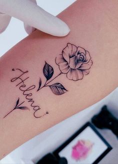 a woman's arm with a tattoo that says happy birthday and flowers on it