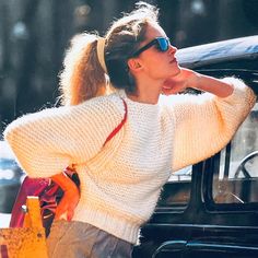 a woman leaning out the window of a car