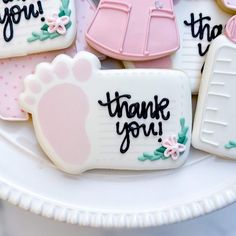 decorated cookies on a plate with thank you written on the top and bottom one cookie