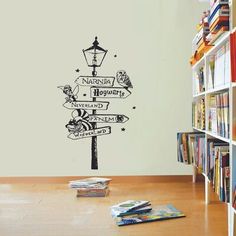 the harry potter sign wall sticker is in front of a bookshelf filled with children's books