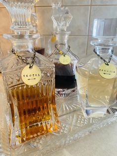 three bottles of perfume sitting on top of a counter