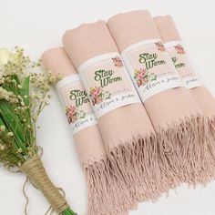 four pink towels with flowers on them next to some twine wrapped in burlock