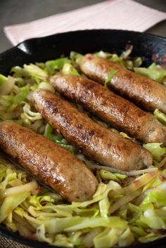 sausages and cabbage cooking in a skillet with the title italian sausage and cabbage