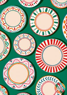 many colorful plates are arranged on a green background