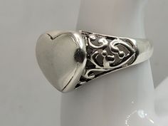 This is a lovely silver filagree heart ring in size 7.75 East Village Bangles is the product of love ❤️, a unique collection of vintage jewelry painstakingly restored by Casey in the East Village. Ours is a people business as much as a jewelry business. Even as we put love, sweat (and sometimes tears!) into restoring these items, it is our policy that you must be thrilled. We stand behind every item and we will take it back if it is not for you. Classic Silver Heart-shaped Ring, Classic Silver Heart Shaped Ring, Vintage Engraved Heart Ring, Silver Heirloom Heart Ring Gift, Classic Silver Heart Ring For Gift, Silver Heirloom Heart Ring, Vintage Sterling Silver Heart Ring Gift, Silver Heirloom Hallmarked Heart Ring, Antique Heart-shaped Promise Ring