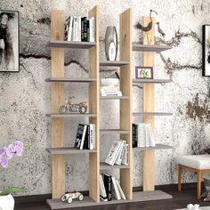 a living room with some bookshelves and pictures hanging on the wall behind them