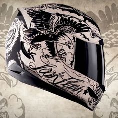 a motorcycle helmet with an eagle on the side and words written in black ink above it