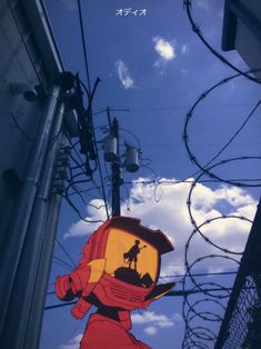 a sign that is hanging from the side of a building with barbed wire around it