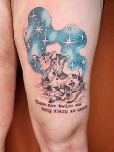 there are two cows that have stars on their butts and one is sitting down