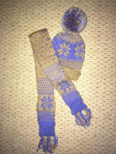 a blue and yellow knitted hat and scarf