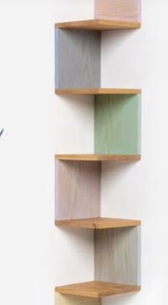 three wooden shelves with different colors on them