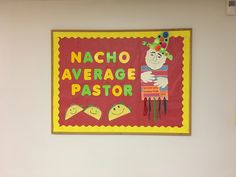 a sign on the wall that says nacho average pastor and two little birds sitting in front of it