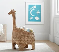 a wicker toy giraffe sitting on top of a rug in a room