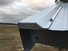 a metal roof in the middle of an open field