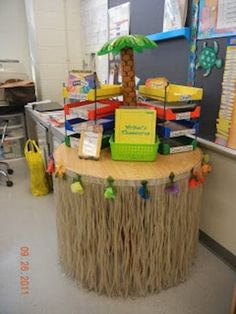 a table with some books on it and a palm tree in the middle of it