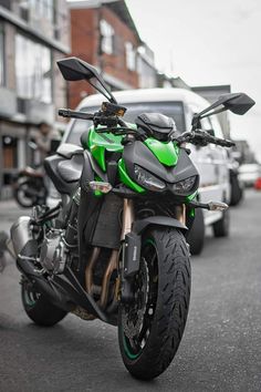 a green and black motorcycle parked on the street